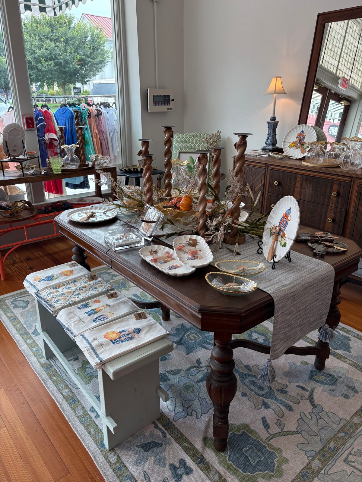 A table set with plates, candlesticks and tea towels